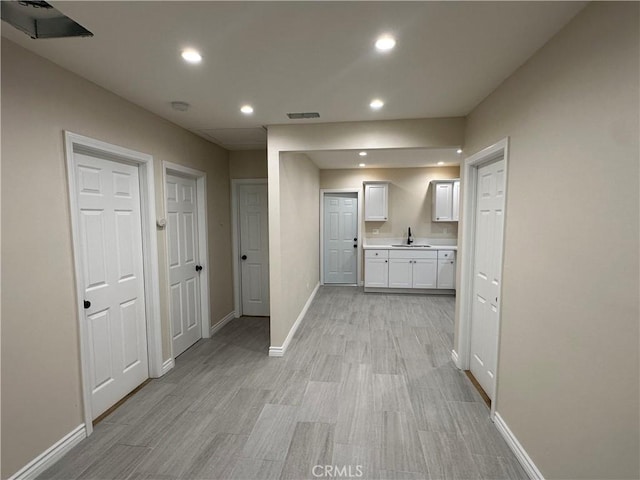 2311 5th St, Riverside, CA 92507 - hall with recessed lighting and light wood-style flooring
