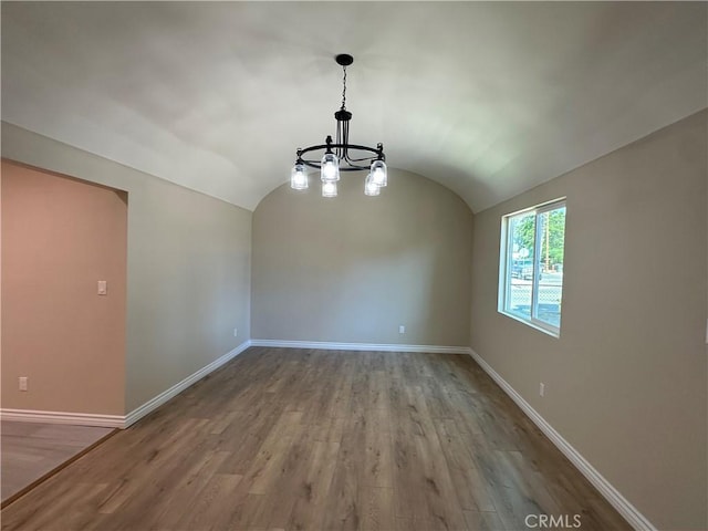 2311 5th St, Riverside, CA 92507 - spare room featuring a chandelier, wood finished floors, and vaulted ceiling