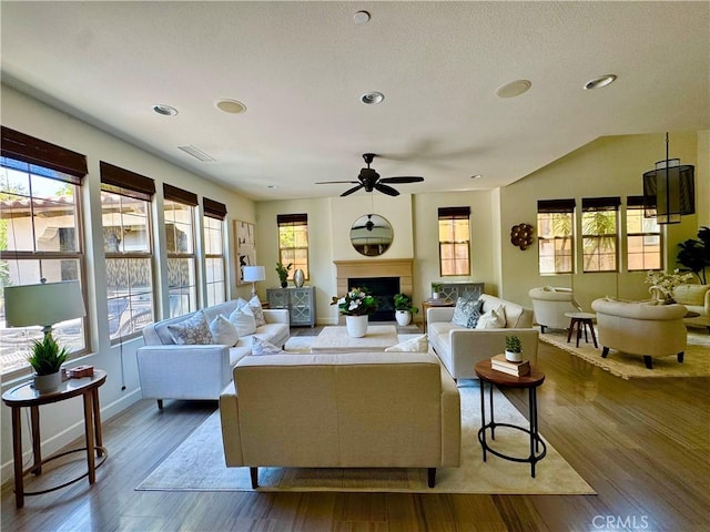 102 Catalonia, Irvine, CA 92618 - living room with dark wood-type flooring, a ceiling fan, a fireplace with raised hearth, and recessed lighting