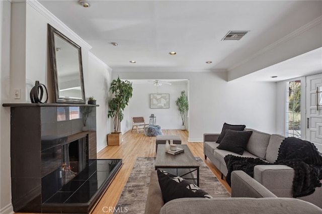 6515 Amigo Ave, Reseda, CA 91335 - living room featuring ornamental molding, wood finished floors, a ceiling fan, a tile fireplace, and recessed lighting
