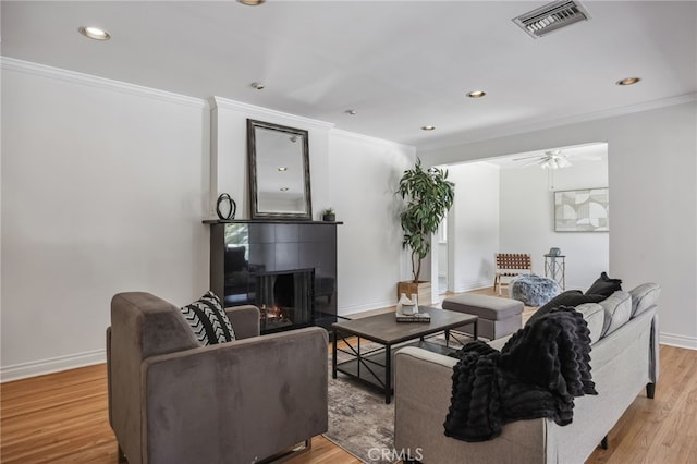 6515 Amigo Ave, Reseda, CA 91335 - living room with a fireplace, light wood-style flooring, a ceiling fan, ornamental molding, and recessed lighting