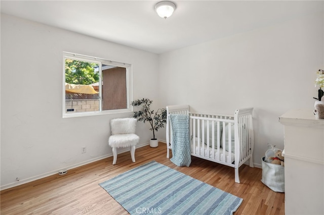 6515 Amigo Ave, Reseda, CA 91335 - bedroom featuring wood finished floors and a nursery area