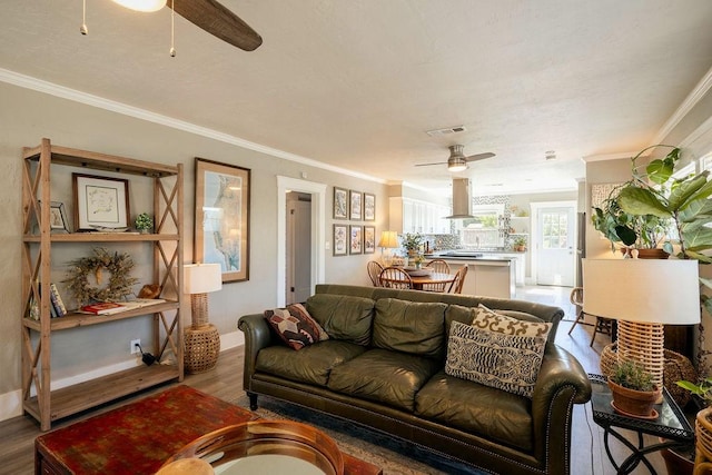 1396 N Ferger Ave, Fresno, CA 93728 - living room featuring ceiling fan, wood finished floors, and ornamental molding