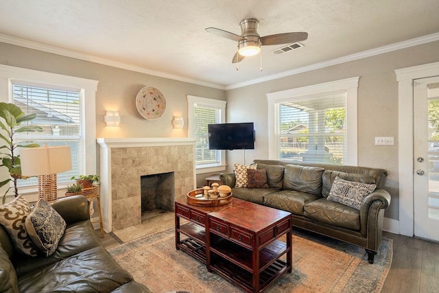 1396 N Ferger Ave, Fresno, CA 93728 - living room with wood finished floors, a ceiling fan, plenty of natural light, ornamental molding, and a fireplace
