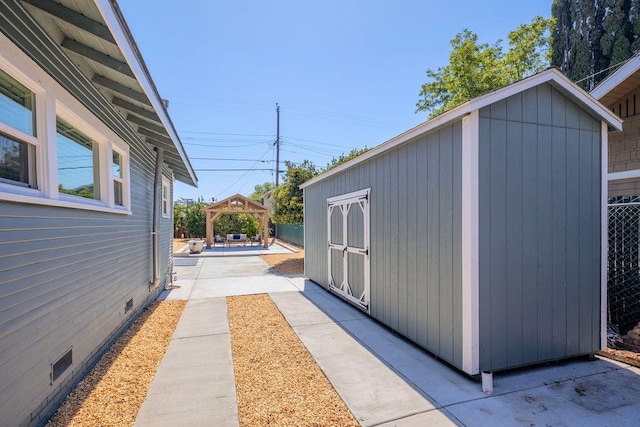 1396 N Ferger Ave, Fresno, CA 93728 - view of side of home featuring a gazebo, a patio, crawl space, and a storage shed