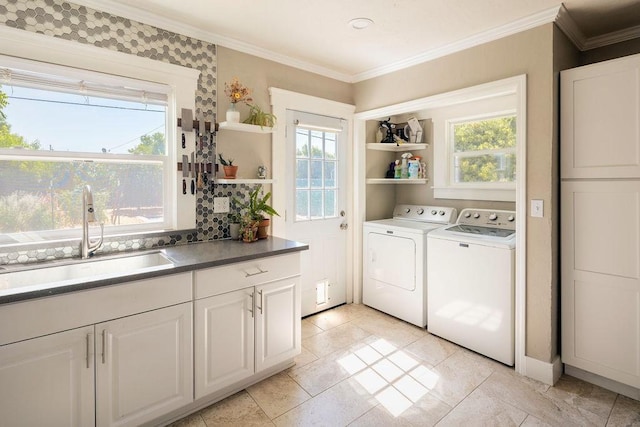 1396 N Ferger Ave, Fresno, CA 93728 - laundry room with washer and clothes dryer, ornamental molding, and light tile patterned flooring