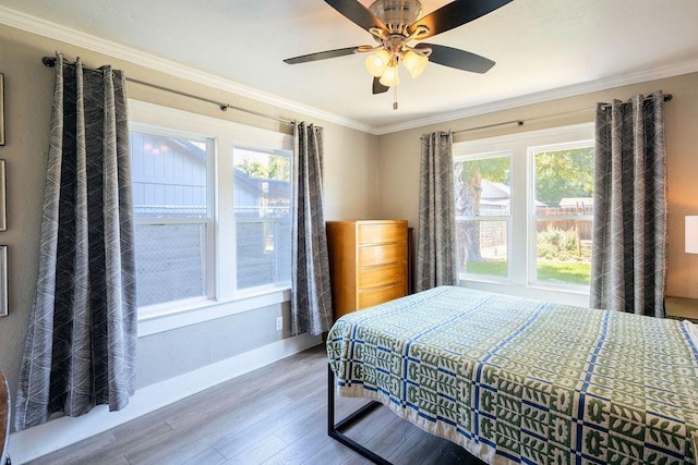1396 N Ferger Ave, Fresno, CA 93728 - bedroom featuring multiple windows, wood finished floors, ornamental molding, and a ceiling fan