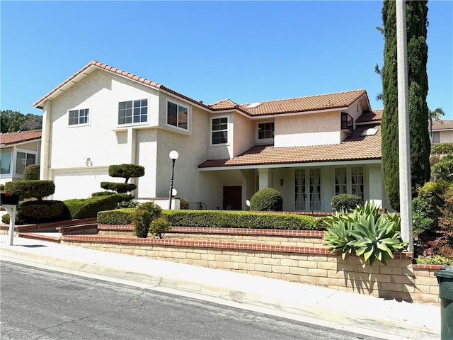 2227 Langspur Dr, Hacienda Heights, CA 91745 - mediterranean / spanish-style house with a tiled roof, stucco siding, a garage, and french doors