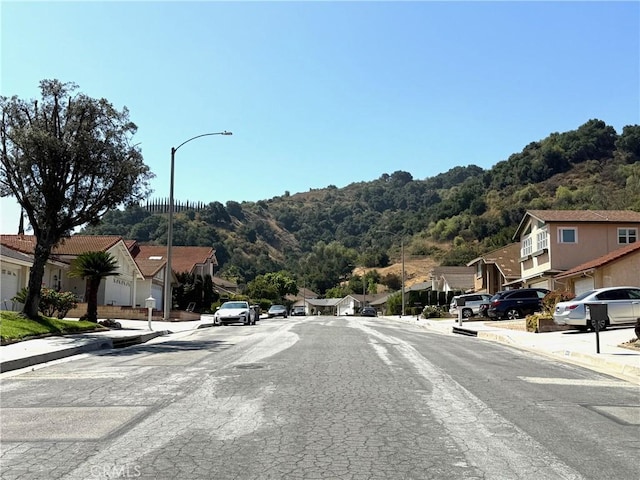 2227 Langspur Dr, Hacienda Heights, CA 91745 - view of asphalt street with sidewalks, curbs, a residential view, and street lighting