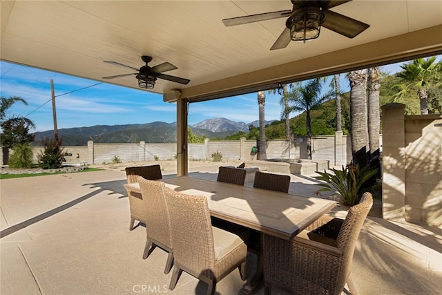 18310 Canon St, Devore, CA 92407 - fenced backyard featuring ceiling fan, a mountain view, a patio area, and outdoor dining area