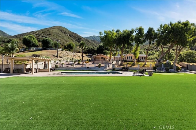 18310 Canon St, Devore, CA 92407 - view of home's community featuring a mountain view, a pergola, a lawn, and a swimming pool