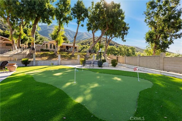 18310 Canon St, Devore, CA 92407 - fenced backyard with a mountain view and a putting area