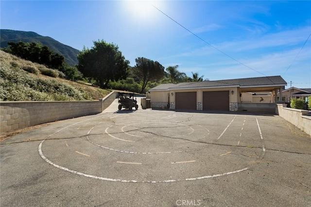 18310 Canon St, Devore, CA 92407 - garage with a mountain view and asphalt driveway