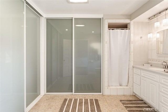 18310 Canon St, Devore, CA 92407 - bathroom featuring vanity, a shower with shower curtain, and tile patterned flooring