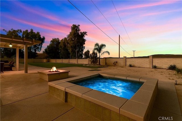 18310 Canon St, Devore, CA 92407 - pool at dusk featuring an outdoor fire pit, an in-ground hot tub, a patio area, and a fenced backyard