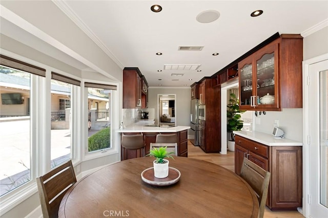 18310 Canon St, Devore, CA 92407 - dining room with healthy amount of natural light, ornamental molding, recessed lighting, and light wood-style floors
