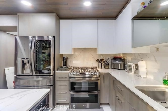 2727 Pine Creek Cir, Fullerton, CA 92835 - kitchen featuring stainless steel appliances, ventilation hood, white cabinetry, modern cabinets, and recessed lighting