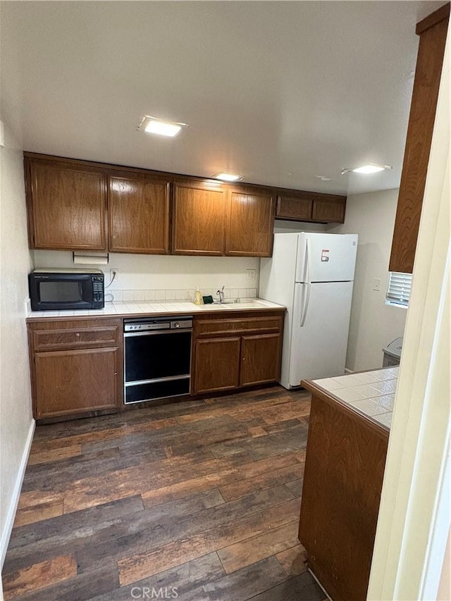 2727 Pine Creek Cir, Fullerton, CA 92835 - kitchen with black appliances, tile countertops, and dark wood-type flooring
