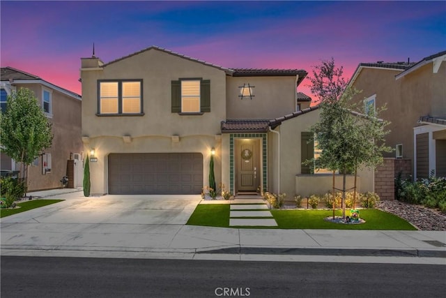 849 Half Moon Ave, Redlands, CA 92374 - mediterranean / spanish-style home with stucco siding, a tile roof, an attached garage, and concrete driveway