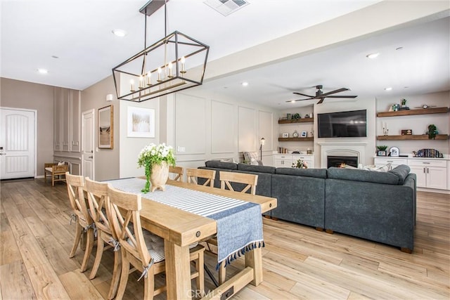 849 Half Moon Ave, Redlands, CA 92374 - dining area featuring ceiling fan, light wood-style floors, a warm lit fireplace, and recessed lighting