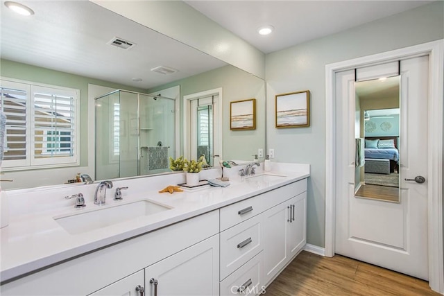 849 Half Moon Ave, Redlands, CA 92374 - ensuite bathroom with double vanity, a stall shower, and wood finished floors