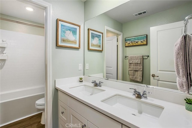 849 Half Moon Ave, Redlands, CA 92374 - full bath with double vanity, wood finished floors, bathtub / shower combination, and recessed lighting