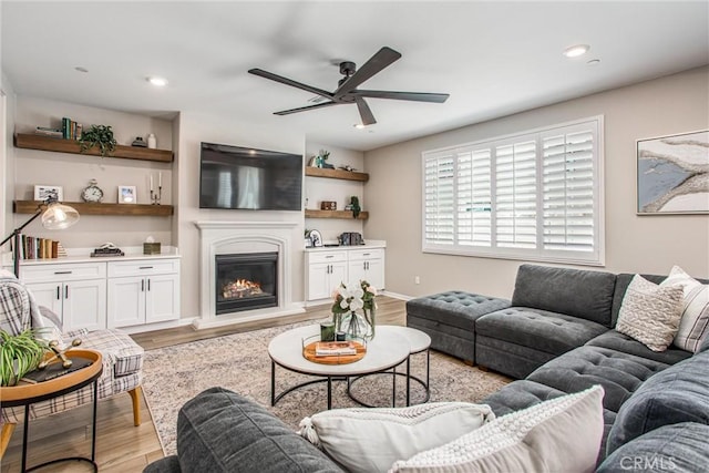 849 Half Moon Ave, Redlands, CA 92374 - living room with ceiling fan, light wood-style flooring, a glass covered fireplace, and recessed lighting