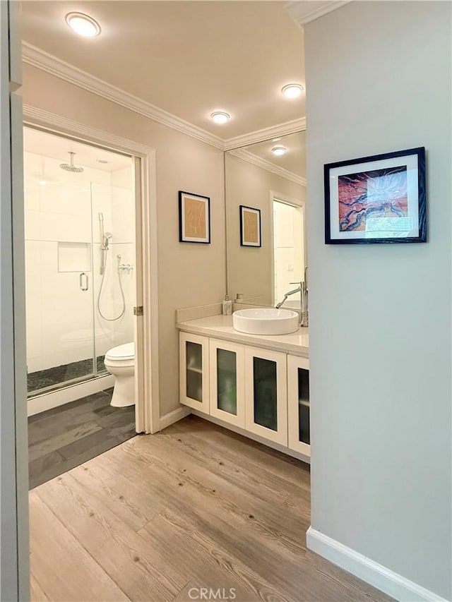 972 Larrabee St Unit 119, West Hollywood, CA 90069 - bathroom with a shower stall, ornamental molding, wood finished floors, and vanity