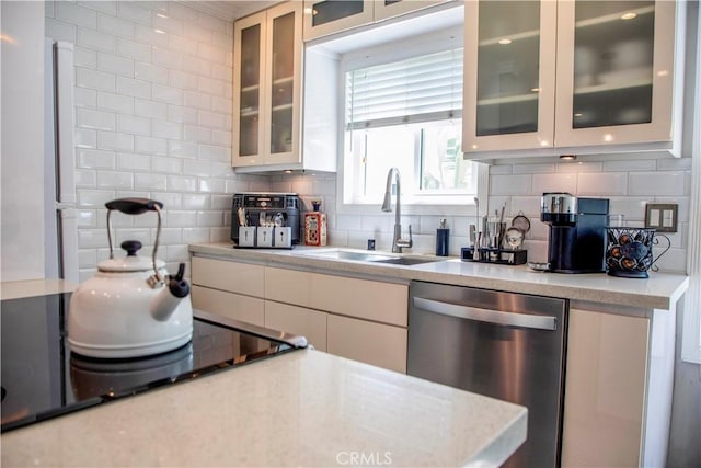 972 Larrabee St Unit 119, West Hollywood, CA 90069 - kitchen featuring dishwasher, tasteful backsplash, black electric stovetop, glass insert cabinets, and white cabinets