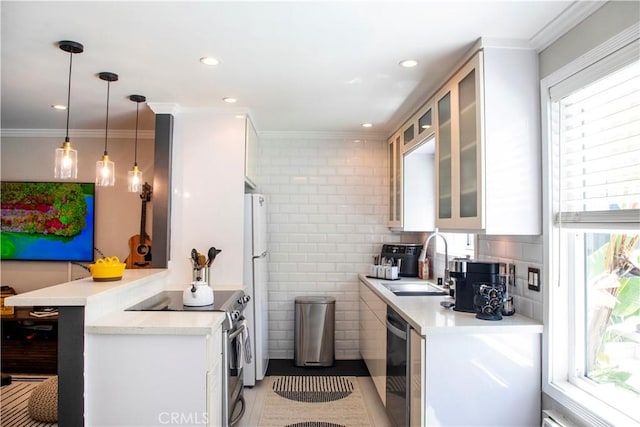 972 Larrabee St Unit 119, West Hollywood, CA 90069 - kitchen with appliances with stainless steel finishes, white cabinetry, light countertops, a peninsula, and crown molding