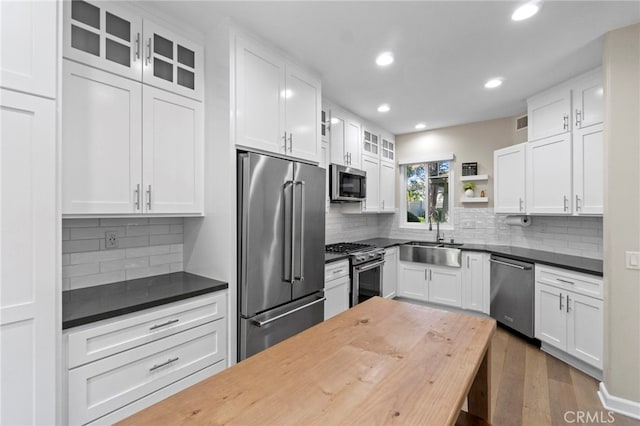 22 Brassie Ln, Coto De Caza, CA 92679 - kitchen with appliances with stainless steel finishes, recessed lighting, open shelves, glass insert cabinets, and backsplash