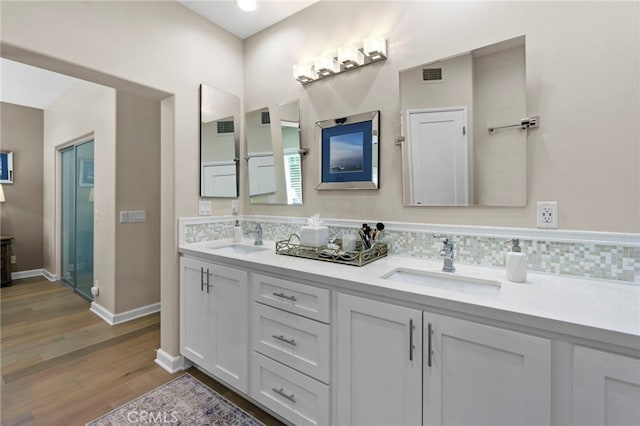 22 Brassie Ln, Coto De Caza, CA 92679 - full bath with double vanity, wood finished floors, and decorative backsplash