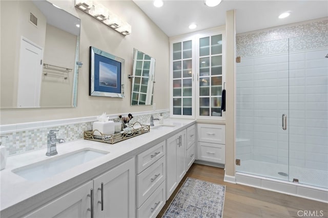 22 Brassie Ln, Coto De Caza, CA 92679 - bathroom featuring a stall shower, double vanity, wood finished floors, and recessed lighting