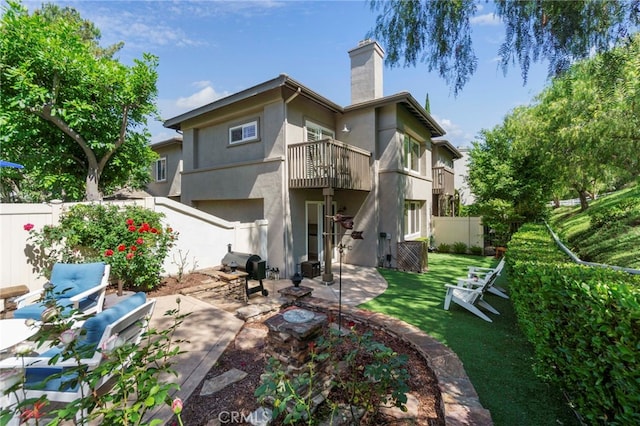 22 Brassie Ln, Coto De Caza, CA 92679 - back of house featuring a balcony, stucco siding, a fenced backyard, a patio area, and a chimney