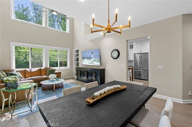 22 Brassie Ln, Coto De Caza, CA 92679 - dining area with a chandelier, light wood-style flooring, and a high ceiling