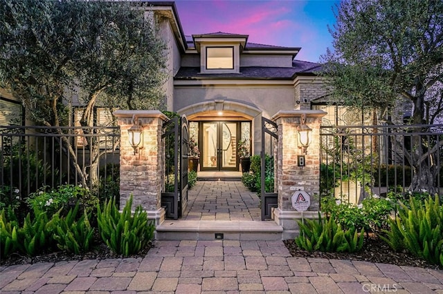 25291 Derbyhill Dr, Laguna Hills, CA 92653 - exterior entry at dusk featuring stucco siding and stone siding