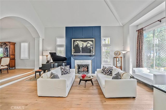 25291 Derbyhill Dr, Laguna Hills, CA 92653 - living area featuring arched walkways, light wood-type flooring, high vaulted ceiling, beam ceiling, and ornate columns