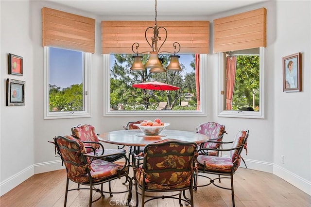 25291 Derbyhill Dr, Laguna Hills, CA 92653 - dining space with light wood finished floors, healthy amount of natural light, and a chandelier