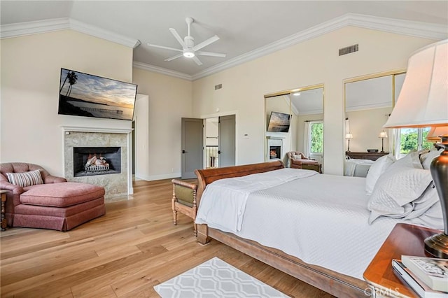 25291 Derbyhill Dr, Laguna Hills, CA 92653 - bedroom with a warm lit fireplace, vaulted ceiling, wood finished floors, ornamental molding, and two closets