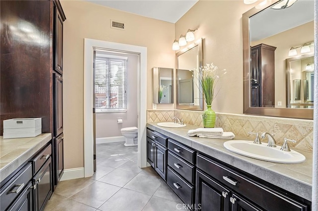 25291 Derbyhill Dr, Laguna Hills, CA 92653 - bathroom featuring double vanity, tile patterned floors, and backsplash