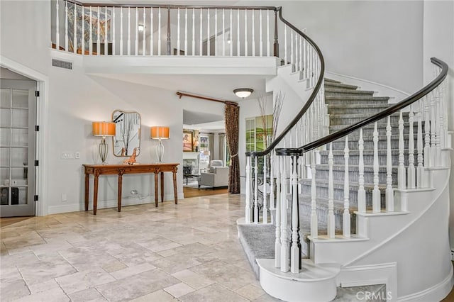 25291 Derbyhill Dr, Laguna Hills, CA 92653 - stairway with a towering ceiling and stone tile flooring