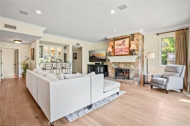 25291 Derbyhill Dr, Laguna Hills, CA 92653 - living area featuring ornamental molding, light wood-type flooring, a stone fireplace, and recessed lighting