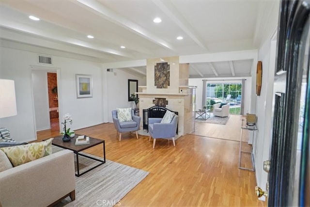5525 Costello Ave, Sherman Oaks, CA 91401 - living room with light wood finished floors, beamed ceiling, a large fireplace, and recessed lighting