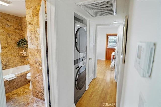 5525 Costello Ave, Sherman Oaks, CA 91401 - laundry room featuring stacked washer / drying machine and light wood finished floors