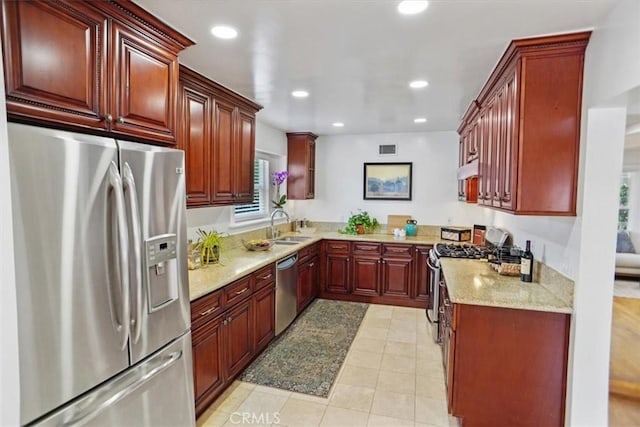 5525 Costello Ave, Sherman Oaks, CA 91401 - kitchen featuring appliances with stainless steel finishes, reddish brown cabinets, light stone countertops, recessed lighting, and under cabinet range hood