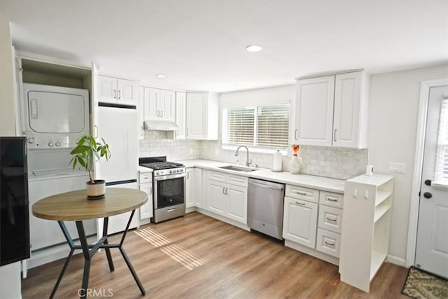 5525 Costello Ave, Sherman Oaks, CA 91401 - kitchen featuring appliances with stainless steel finishes, stacked washer / drying machine, under cabinet range hood, decorative backsplash, and recessed lighting