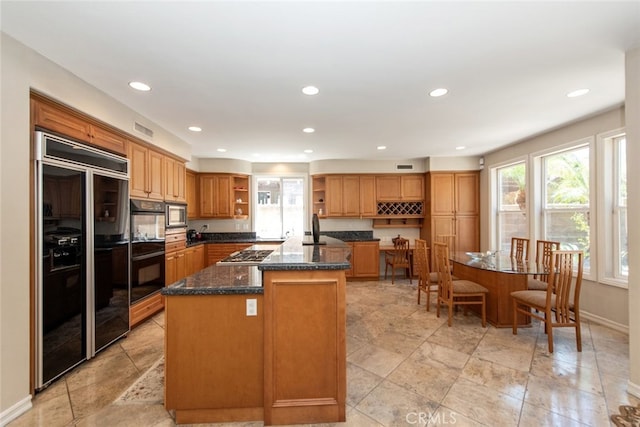 2 Shadow, Irvine, CA 92620 - kitchen featuring open shelves, built in appliances, a center island, recessed lighting, and dark stone counters