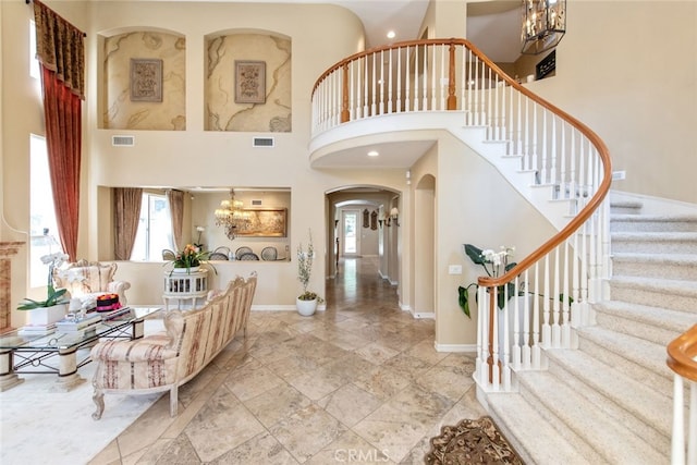 2 Shadow, Irvine, CA 92620 - entrance foyer featuring a chandelier, arched walkways, plenty of natural light, a towering ceiling, and stairway
