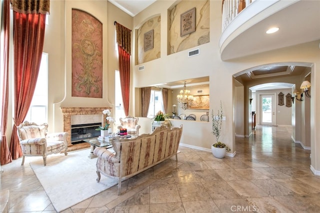 2 Shadow, Irvine, CA 92620 - living room featuring arched walkways, a high ceiling, a premium fireplace, and a chandelier