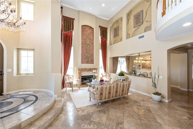 2 Shadow, Irvine, CA 92620 - living area featuring a chandelier, a high ceiling, arched walkways, a glass covered fireplace, and inlaid floor details